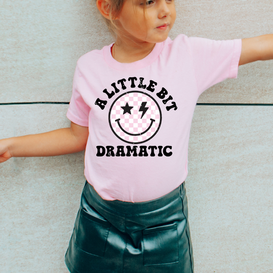 trendy and playful kids graphic tee in Ballerina color with a smiling design.